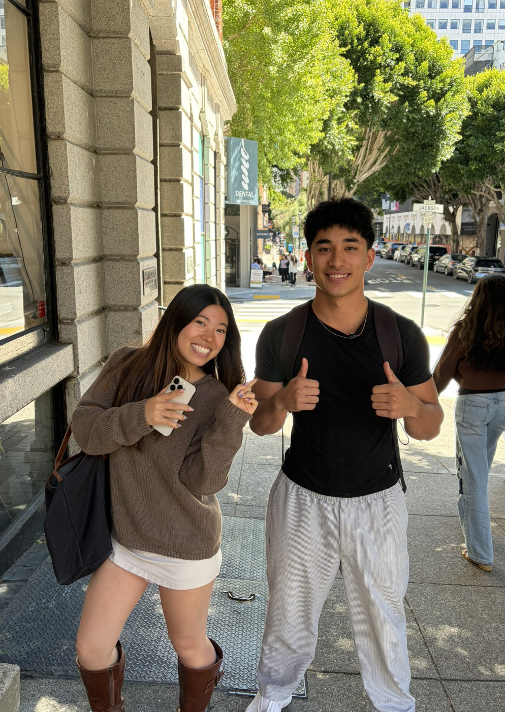 Two friends on a sunny San Francisco sidewalk