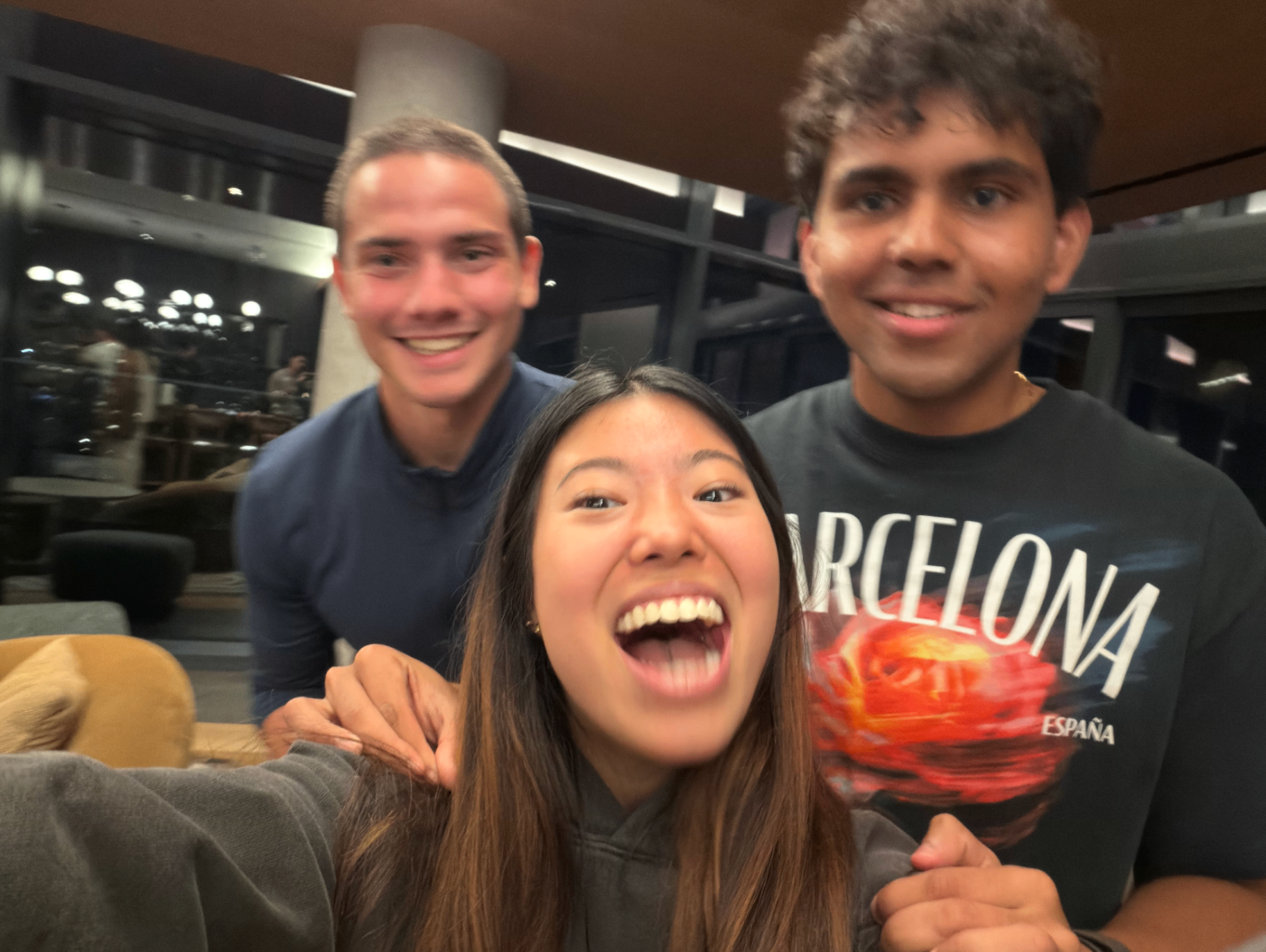 Teagan and friends laughing in a hotel lobby