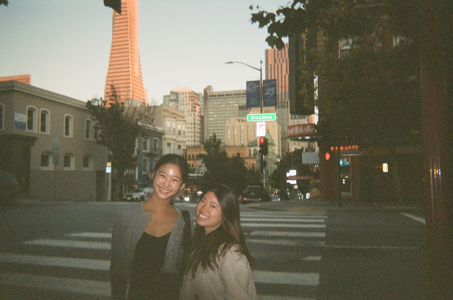 Two friends on Broadway at dusk in San Francisco