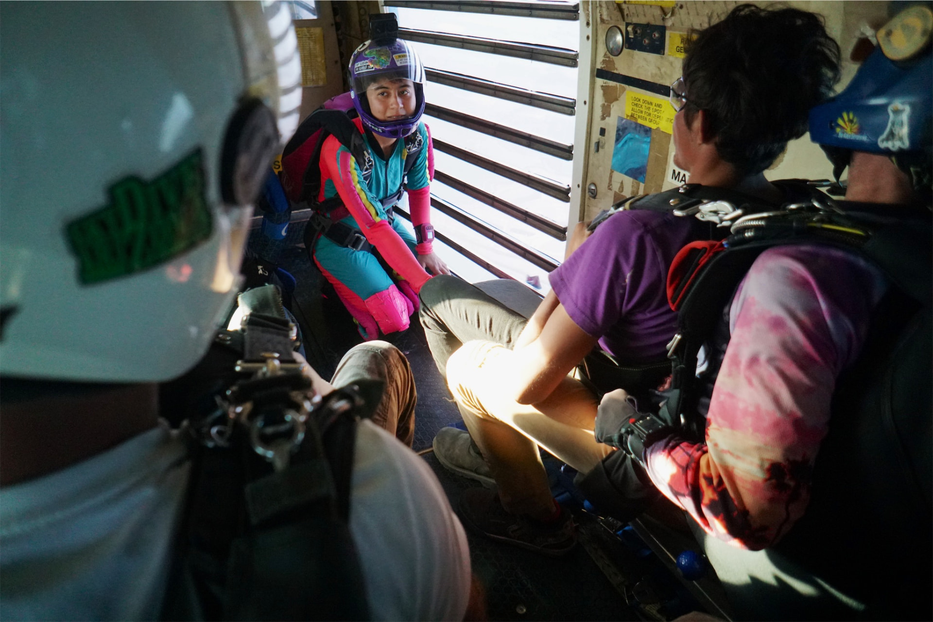 Skydivers seated in the plane before the jump