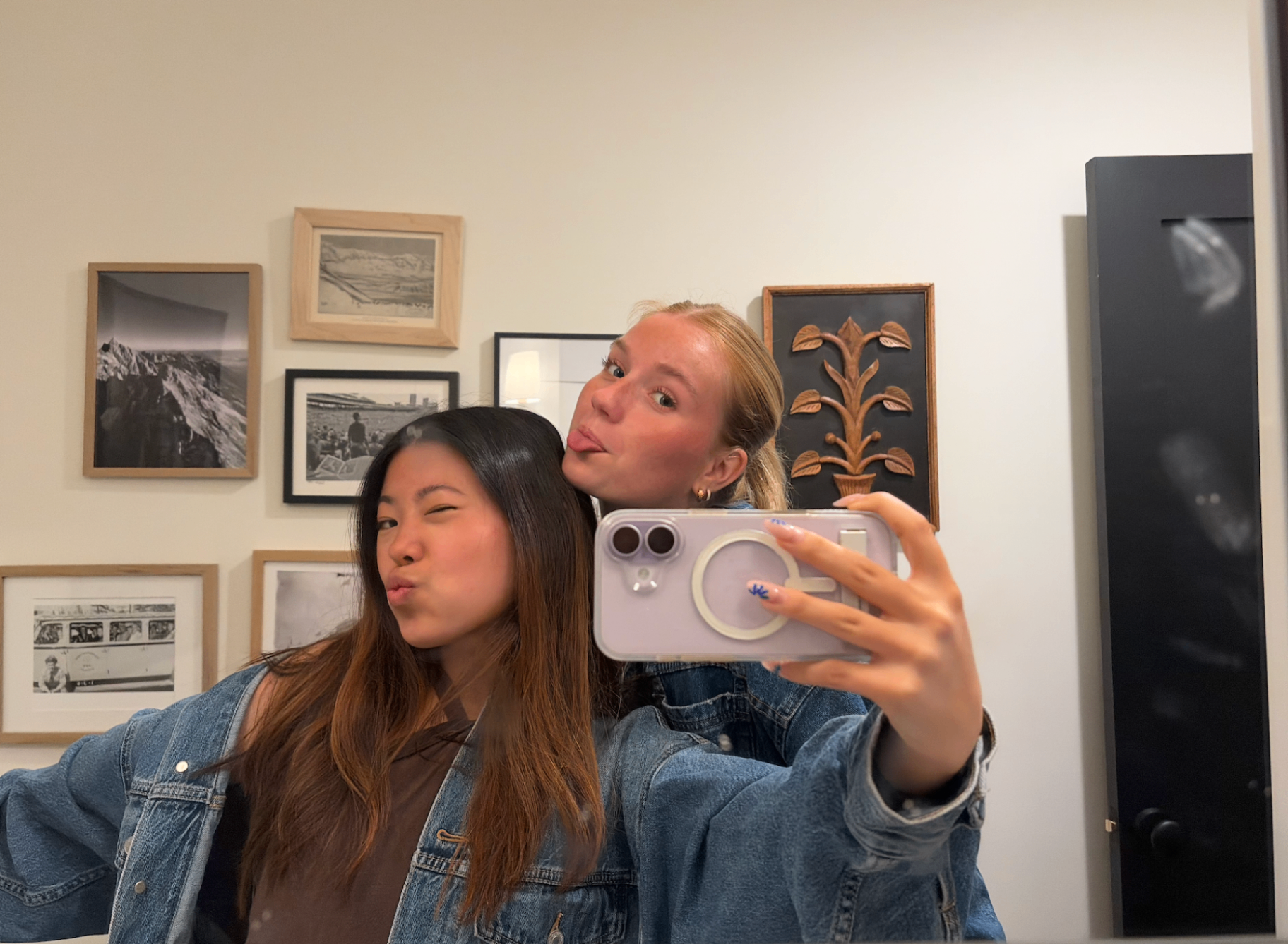 Teagan and a friend making faces in a mirror selfie